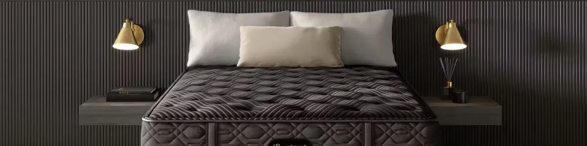 photo of a beauty rest black mattress in a bed room with two sconces and black painted walls